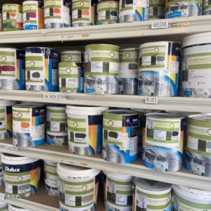 Photo of Dulux Weathershield tins and tubs on shelves in a shop