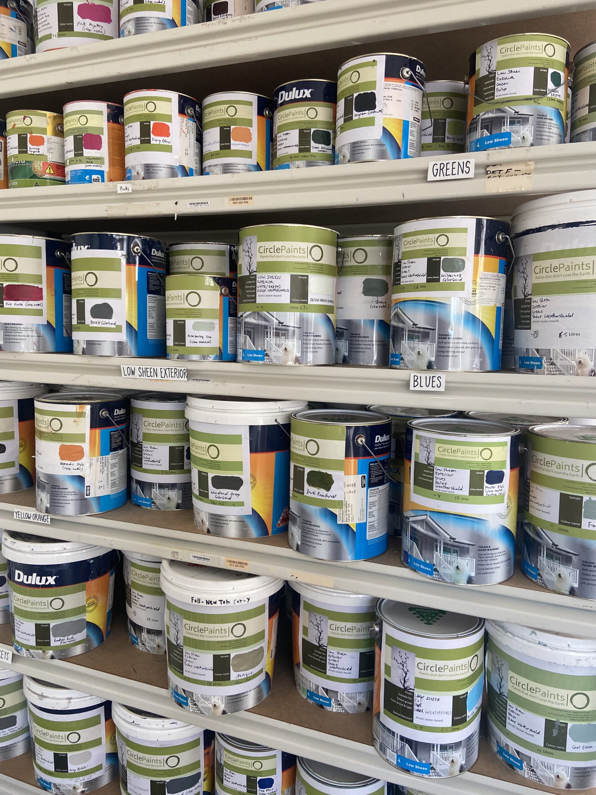 Photo of Dulux Weathershield tins and tubs on shelves in a shop